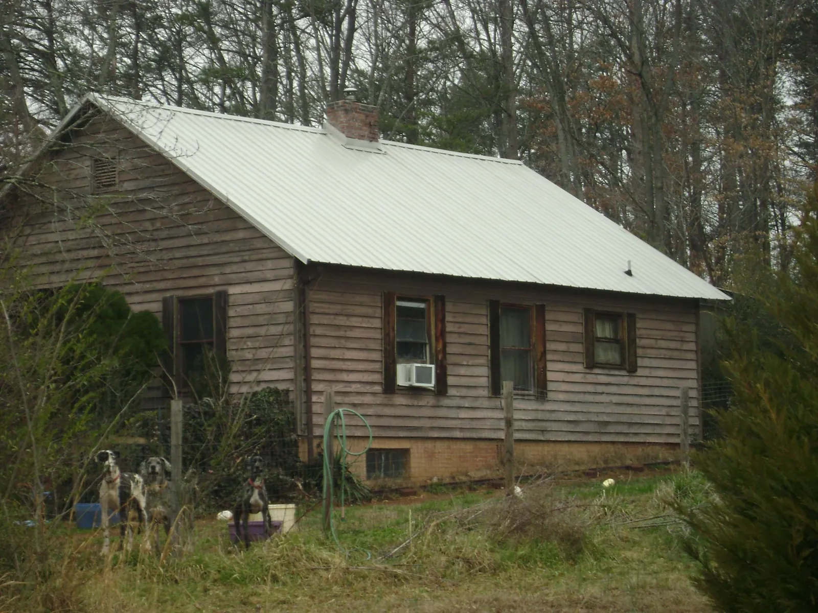White metal roof on an old wood sided farmhouse, from a Asphalt Shingle Roof Repair job in East Brunswick